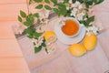 Green tea, lemon and jasmine flowers on wooden background. Royalty Free Stock Photo