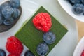 Green tea matcha mousse cake with berries Royalty Free Stock Photo