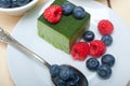 Green tea matcha mousse cake with berries Royalty Free Stock Photo