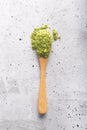 Green tea matcha in a spoon on concrete surface. Close up shot Royalty Free Stock Photo