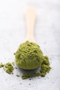 Green tea matcha in a spoon on concrete surface. Close up shot Royalty Free Stock Photo
