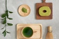 Green tea matcha in a wooden cup with German cake on the brown mat close-up Royalty Free Stock Photo