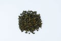 Green tea milk oolong. Dry leaves in  loose heap. White background Royalty Free Stock Photo