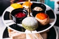 Green Tea Scone topping with icing and Plain Scone on black and white color plate. Served with jam and butter