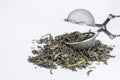 Green tea and sieve, on white background Royalty Free Stock Photo