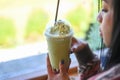 green tea smoothie plastic cup woman hand holding a cup green tea in cafe, young woman drinking milk tea relaxed woman