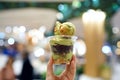 Green tea soft serve - A cup of matcha ice cream topped with red bean and choux cream on blurred background, Traditional Japanese Royalty Free Stock Photo