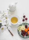 Green tea, summer seasonal fruits and berries on a light background. Delicious healthy snack Royalty Free Stock Photo