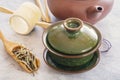 Green tea in a wooden spoon, attributes for a tea ceremony and the traditional Chinese porcelain green cup Royalty Free Stock Photo