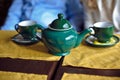 Green teapot and two cups of tea Royalty Free Stock Photo