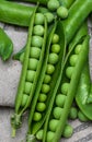 Green, tender, fresh and raw peas.