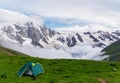 Green tent in beautiful mountains landscape