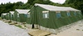 Green tent camp in Pyrenees for Santiago pilgrims Royalty Free Stock Photo