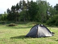 Green tent in green field