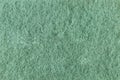 Green texture from the surface of the back of the foam sponge close-up. Textured background Royalty Free Stock Photo