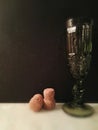 Green vintage glass and two champagne corks. Royalty Free Stock Photo