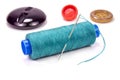 Green thread on a plastic spool with needle and buttons on white background Royalty Free Stock Photo