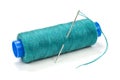 Green thread on a plastic spool with needle on white background Royalty Free Stock Photo