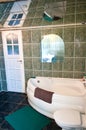 Green tiled bathroom with mirror ceiling Royalty Free Stock Photo