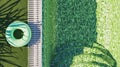Green tiled pool edge with grass and ring float Royalty Free Stock Photo