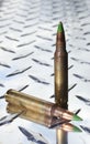 Green tipped rifle shells on chrome metal Royalty Free Stock Photo