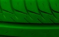 green tire tread macro photo on tapete