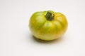 Green tomato on plain background, healthy food