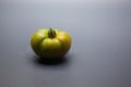 Green tomato on plain background, healthy food