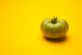 Green tomato on plain background, healthy food