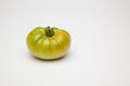 Green tomato on plain background, healthy food