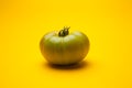 Green tomato on plain background, healthy food