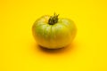 Green tomato on plain background, healthy food