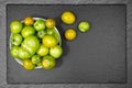 Green tomatoes on slate slab