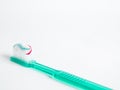 The green toothbrush with a red blue and white striped toothpaste Royalty Free Stock Photo