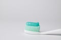 Green toothpaste on a toothbrush on white background Royalty Free Stock Photo