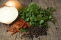 Green tops of parsley, onion, black pepper beans and dry chili Royalty Free Stock Photo