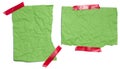 Green torn pieces of paper taped with electrical tape on a white isolated background