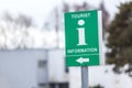 Green tourist information sign with direction arrow