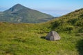 Green tourist tent in camp among meadow in the mountain.Nature background Royalty Free Stock Photo