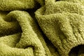 A green towel with a fuzzy texture