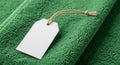 Green towel with a textured, looped surface. A white paper tag is attached with a Royalty Free Stock Photo