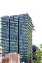 Green tower block in Sydney Australia covered in foliage.