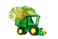 Green toy agricultural tractor, harvesting, farming machinery on a white background place for text, isolate.