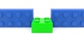 Green toy brick between two blue toy bricks