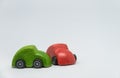 Green toy car accident crashed red toy car with white background and selective focus Royalty Free Stock Photo