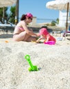 Green toy spade in the sand Royalty Free Stock Photo