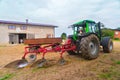 Green tractor and a plow Royalty Free Stock Photo