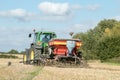 A green tractor with a seed drill in a stubble field Royalty Free Stock Photo