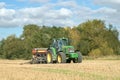 A green tractor with a seed drill in a stubble field Royalty Free Stock Photo