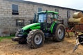 Green tractor and straw rolls Royalty Free Stock Photo